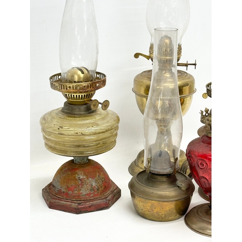 739 - A large collection of oil lamps, shades and funnels.