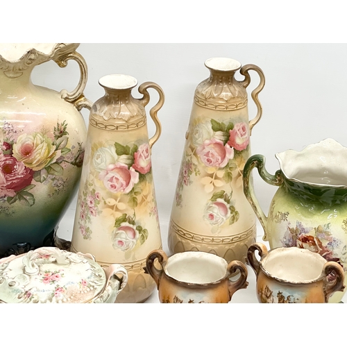 748 - A collection of Late Victorian/Edwardian pottery vases and a biscuit barrel.