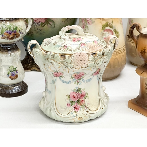 748 - A collection of Late Victorian/Edwardian pottery vases and a biscuit barrel.