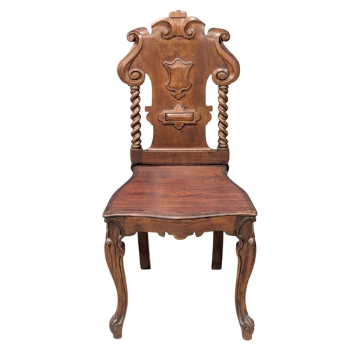 888 - A 19th Century Victorian mahogany shield back hall chair. Circa 1860.