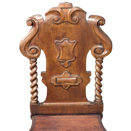 888 - A 19th Century Victorian mahogany shield back hall chair. Circa 1860.