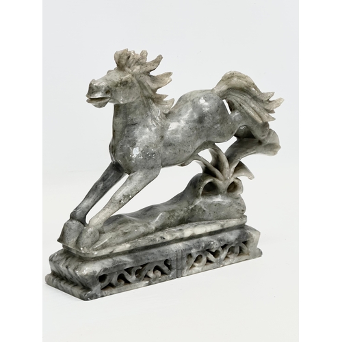 937 - A pair of Chinese soapstone horses. 21x19cm