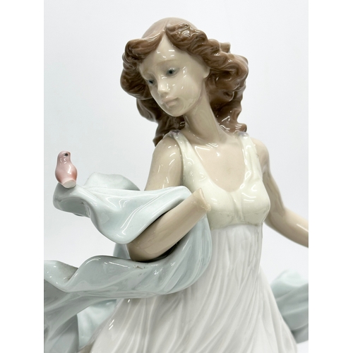 938 - A collection of Lladro and NAO figurines. 32cm. 30cm. 29cm. 24cm. 23cm