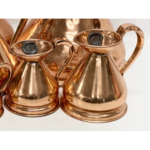 708 - A set of 8 Victorian copper measuring jugs.