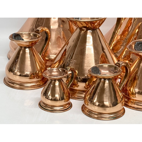 708 - A set of 8 Victorian copper measuring jugs.