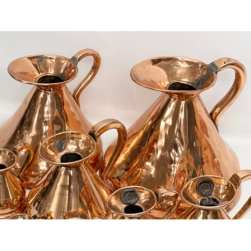 708 - A set of 8 Victorian copper measuring jugs.