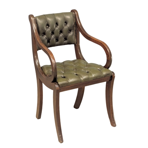 370B - A Regency style mahogany deep button back leather armchair.