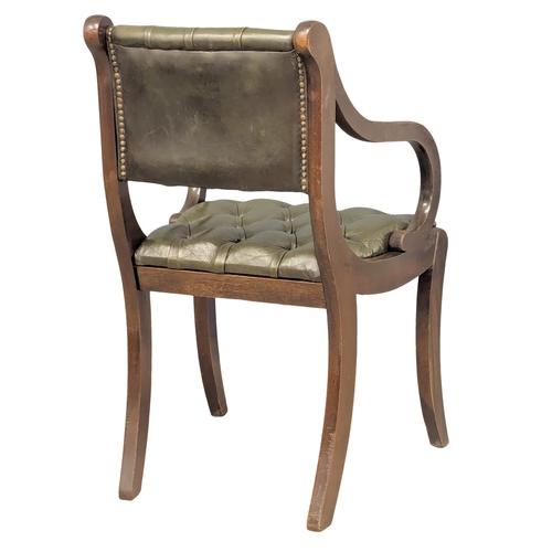 370B - A Regency style mahogany deep button back leather armchair.