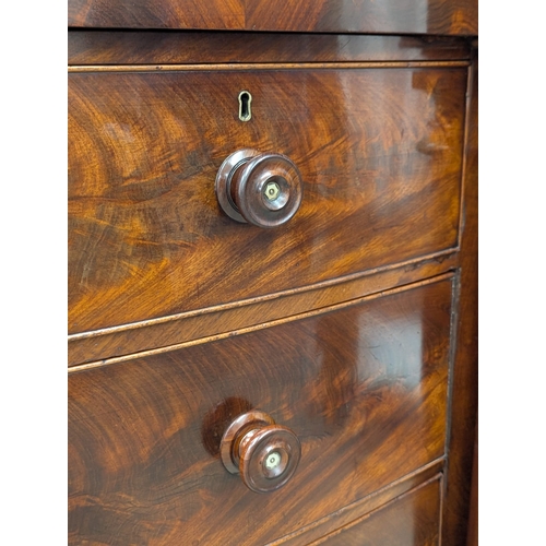 390B - A large good quality 19th Century Victorian flamed mahogany bow front chest on drawers with Doric co... 