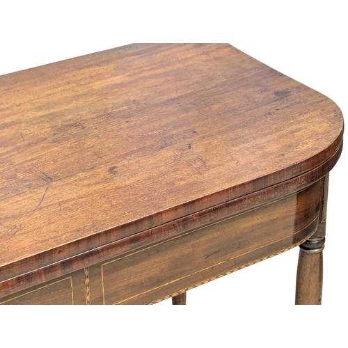 473 - An Early 19th Century George IV inlaid mahogany turnover tea table on turned legs. Circa 1820. 103x5... 