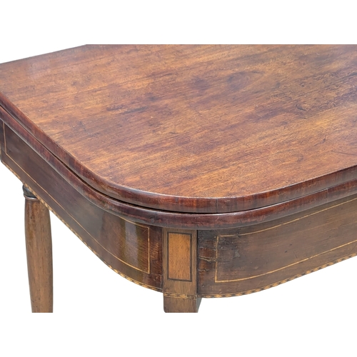 473 - An Early 19th Century George IV inlaid mahogany turnover tea table on turned legs. Circa 1820. 103x5... 