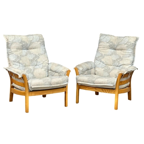 522 - A pair of Ercol blonde elm “Saville” armchairs.