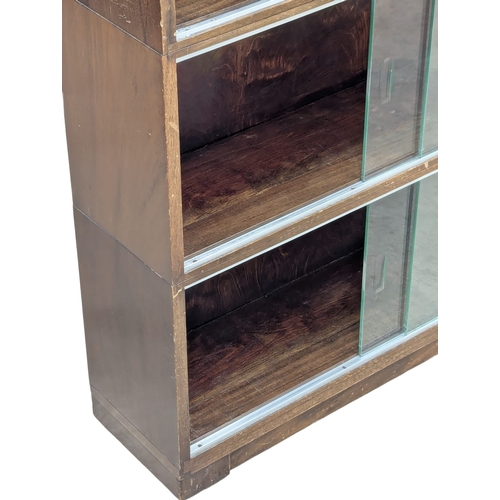 554 - A Mid 20th Century mahogany bookcase by Minty. Circa 1950s. 89x23x99.5cm