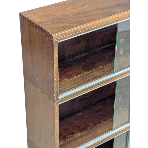 554 - A Mid 20th Century mahogany bookcase by Minty. Circa 1950s. 89x23x99.5cm