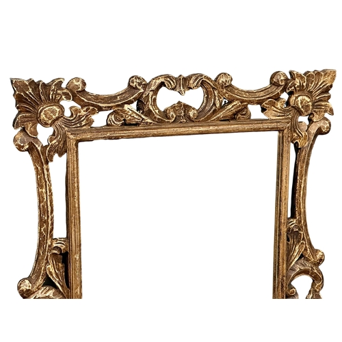 818 - A large ornate framed mirror. 80x121cm