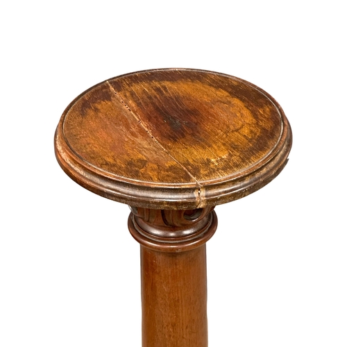 823 - A 19th Century Victorian mahogany torchere with later top and base. 126cm