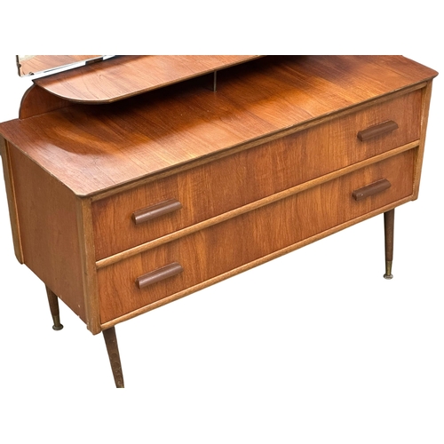 824 - A Mid Century teak dressing table. 108x42x120cm