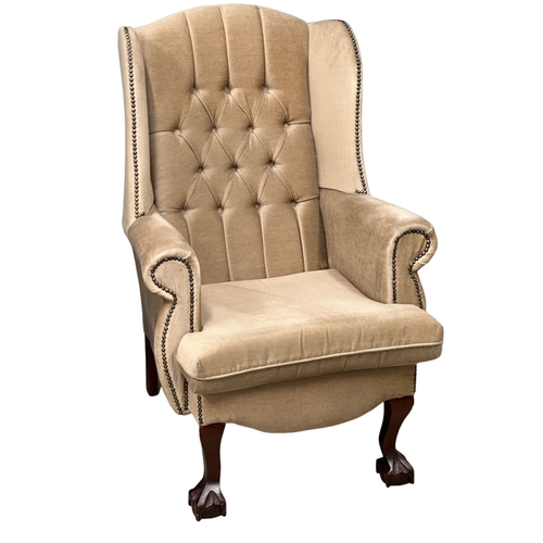 825 - A pair of deep button wingback armchairs.