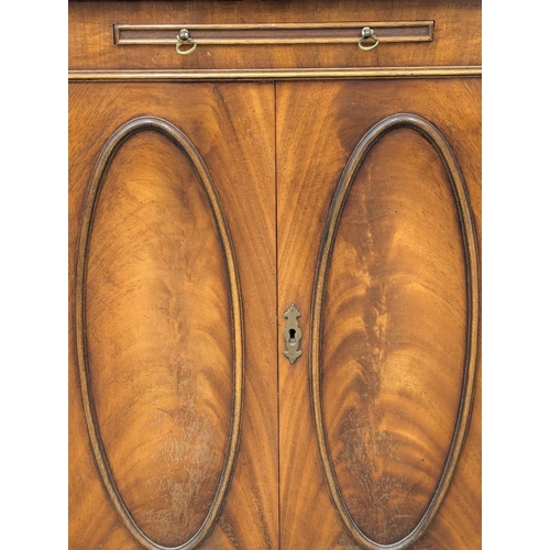 826 - A Georgian style mahogany corner cocktail cabinet. 66x173cm