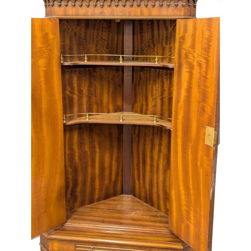 826 - A Georgian style mahogany corner cocktail cabinet. 66x173cm