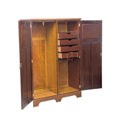 852 - An Early 20th Century mahogany fitted wardrobe. 129x55x188cm. 1