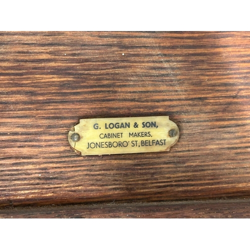 864 - A large G. Logan & Son Cabinet Makers, Belfast oak desktop organiser. Late 19th/Early 20th Century. ... 