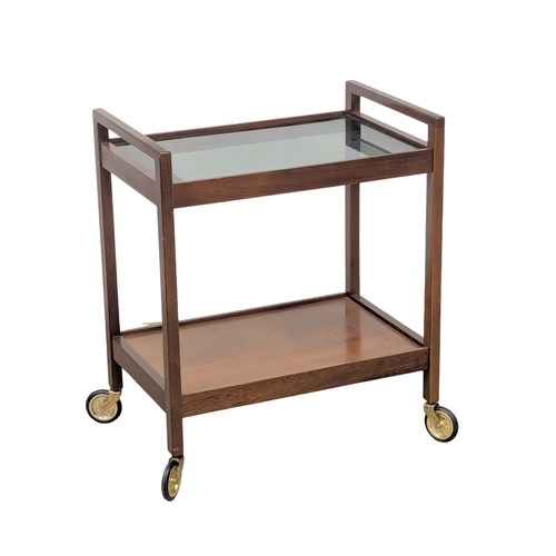 935 - A Mid Century teak serving trolley with smoked glass top. 62x42x73cm (3)