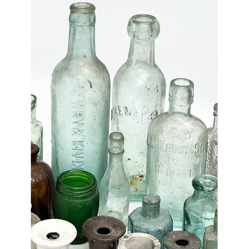 738 - A large collection of Late 19th and Early 20th Century glass bottles and stoneware bottles etc.