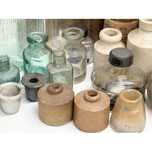 738 - A large collection of Late 19th and Early 20th Century glass bottles and stoneware bottles etc.