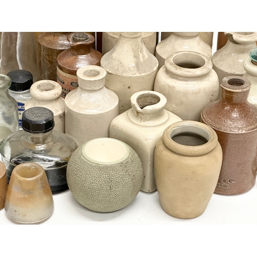 738 - A large collection of Late 19th and Early 20th Century glass bottles and stoneware bottles etc.