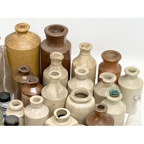 738 - A large collection of Late 19th and Early 20th Century glass bottles and stoneware bottles etc.