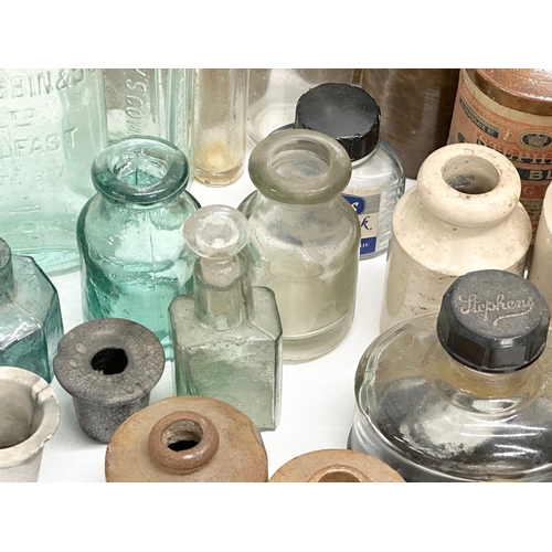 738 - A large collection of Late 19th and Early 20th Century glass bottles and stoneware bottles etc.