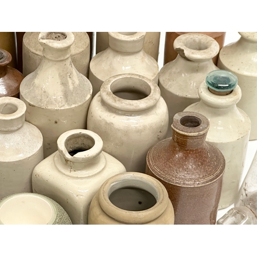 738 - A large collection of Late 19th and Early 20th Century glass bottles and stoneware bottles etc.