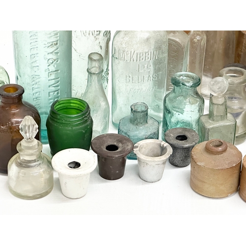 738 - A large collection of Late 19th and Early 20th Century glass bottles and stoneware bottles etc.