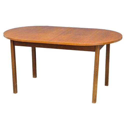 948 - A Mid Century teak extending dining. 195x91x75cm (6)