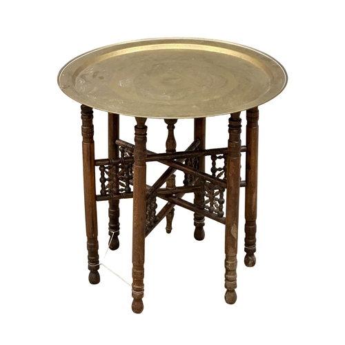 950A - An Early 20th Century Burmese folding table with brass tray. 58x59cm (3)