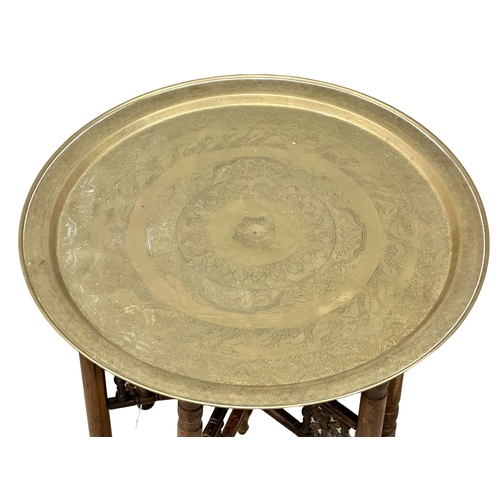 950A - An Early 20th Century Burmese folding table with brass tray. 58x59cm (3)