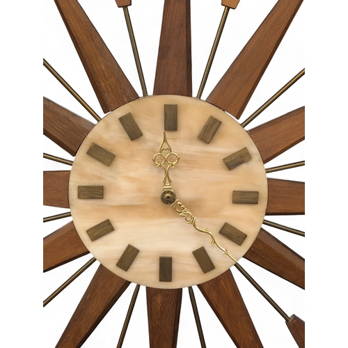 A mid century teak and marble sunburst clock by Manley, 69.5cm (7)
