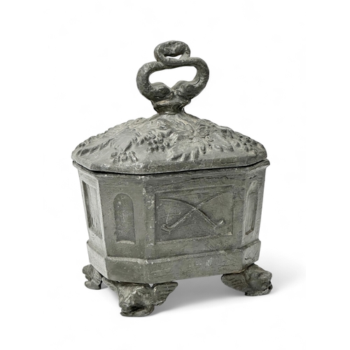 312 - An Early 19th Century English George III lead tobacco box. Depicting smokers pipes, four griffin fee... 
