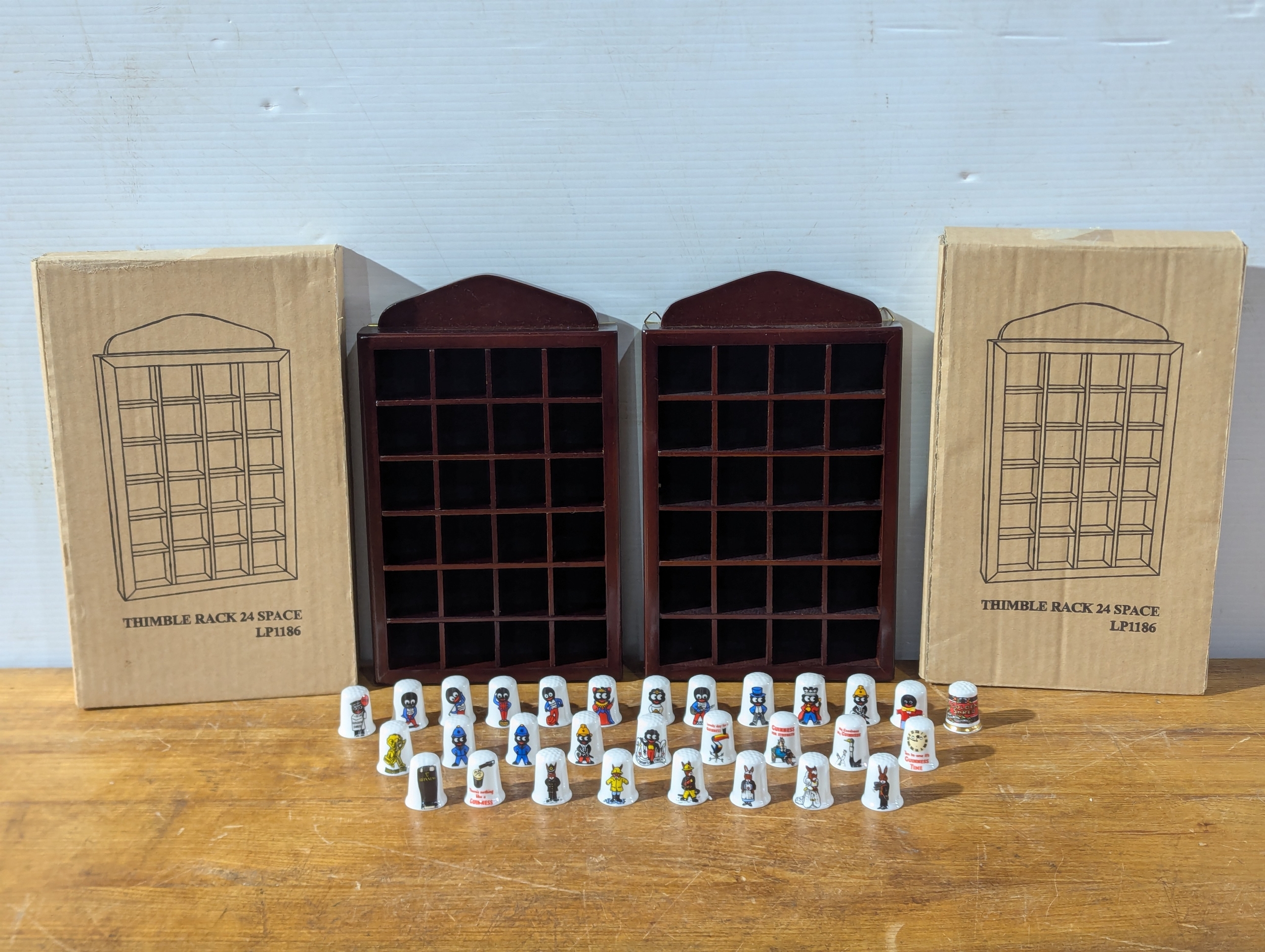 Pair of Thimble racks with Golly, Guinness and other Thimbles