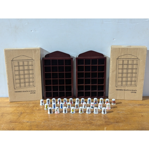 Pair of Thimble racks with Golly, Guinness and other Thimbles