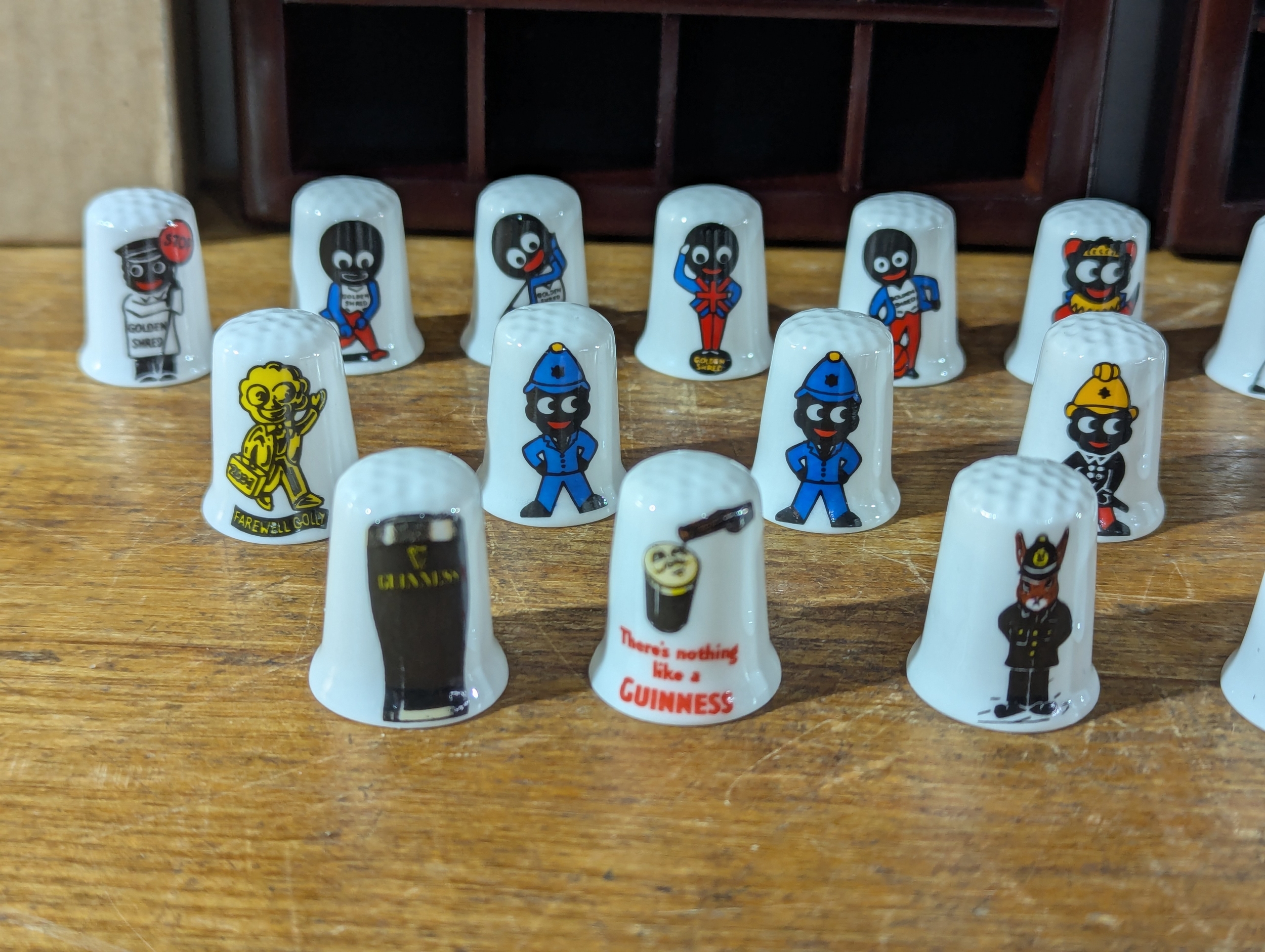 Pair of Thimble racks with Golly, Guinness and other Thimbles
