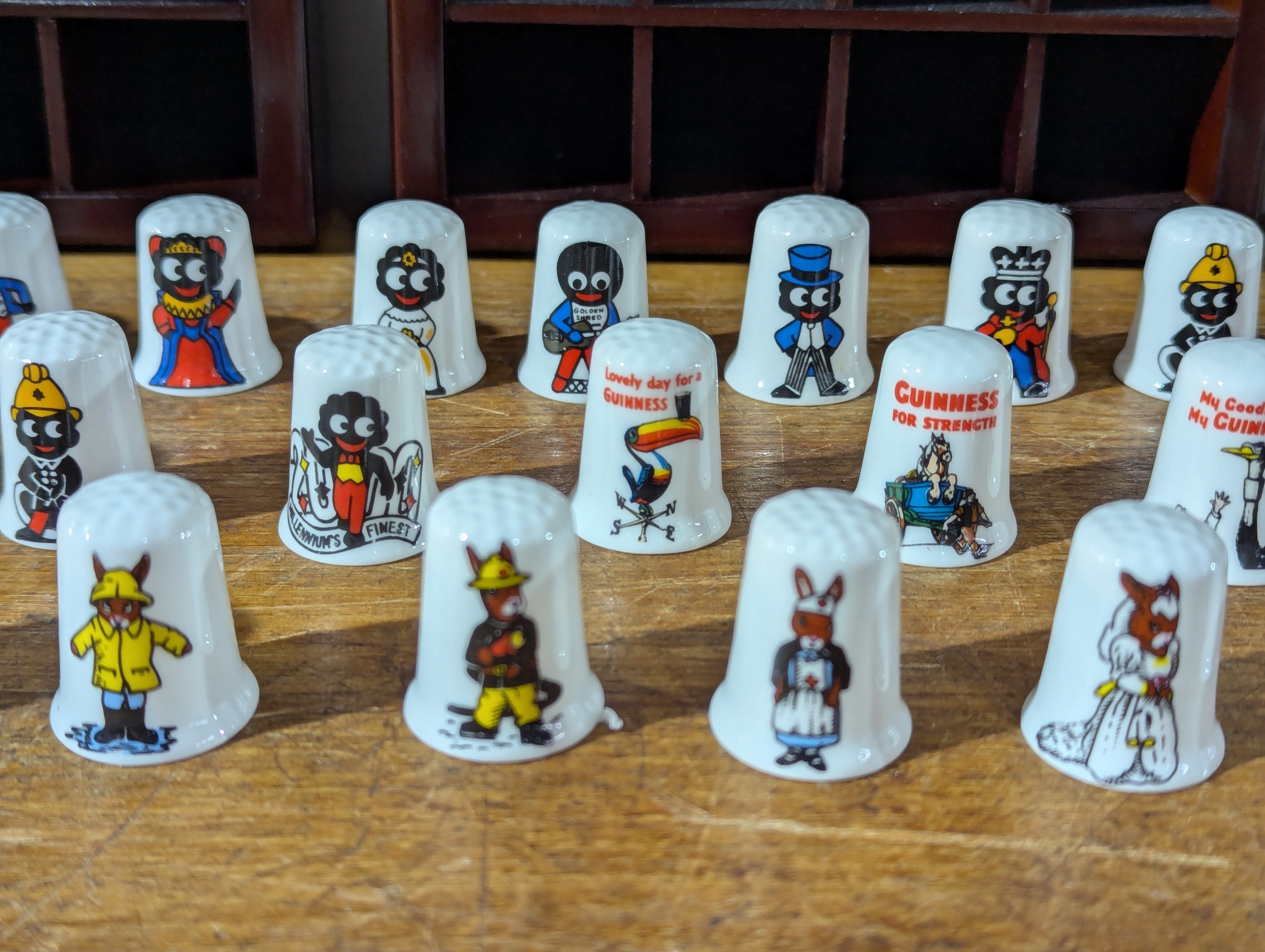 Pair of Thimble racks with Golly, Guinness and other Thimbles