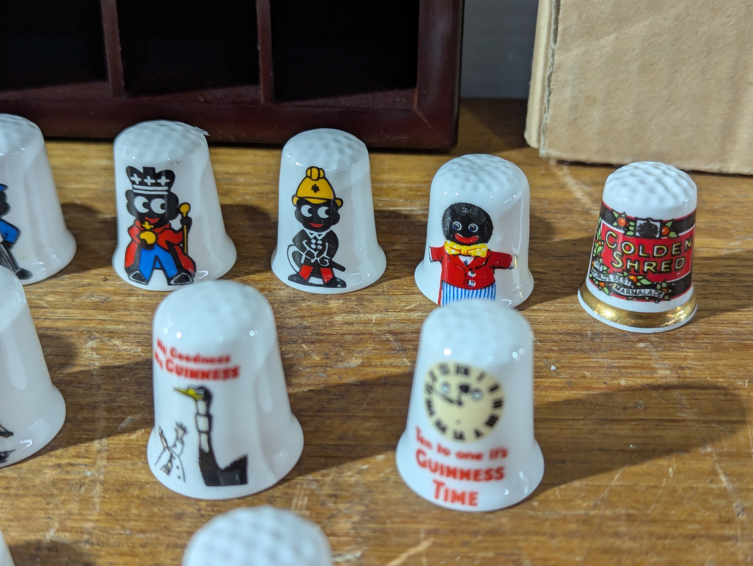 Pair of Thimble racks with Golly, Guinness and other Thimbles