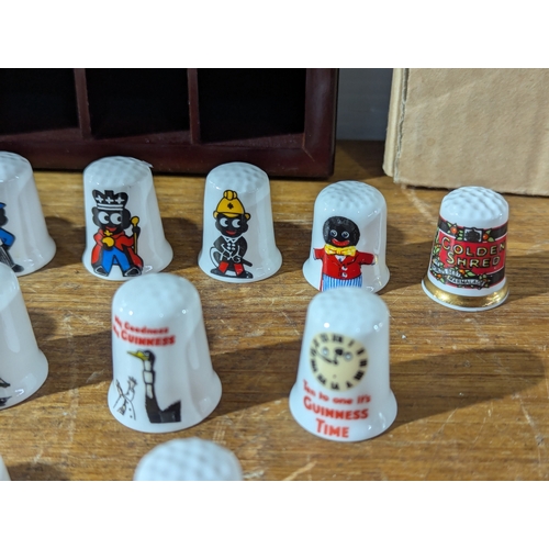 Pair of Thimble racks with Golly, Guinness and other Thimbles