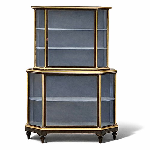 A Victorian brass and ebonised shop’s display cabinet. C.1860, 19th Century. With breakfront, brass inlay and mounts and original upholstered interior. Two piece. 111x37x180cm.