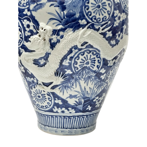 59 - An extra large Japanese Arita pot. Meiji Period (1868-1912) Late 19th Century. Two moulded relief dr... 