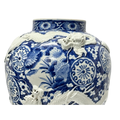 59 - An extra large Japanese Arita pot. Meiji Period (1868-1912) Late 19th Century. Two moulded relief dr... 
