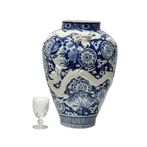 59 - An extra large Japanese Arita pot. Meiji Period (1868-1912) Late 19th Century. Two moulded relief dr... 