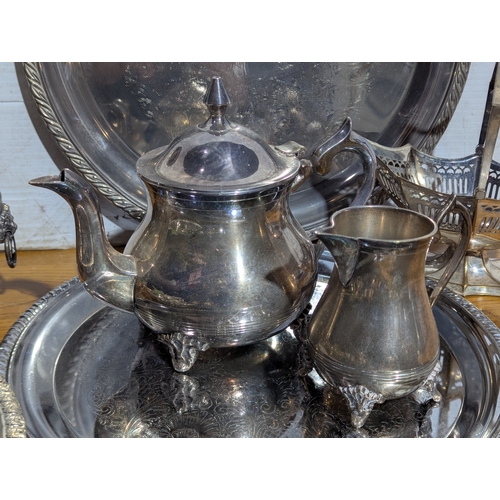 263 - Quantity of EPNS serving trays, coffee and tea pot, butter dishes etc